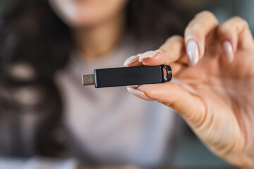 unknown woman hold usb type c at home