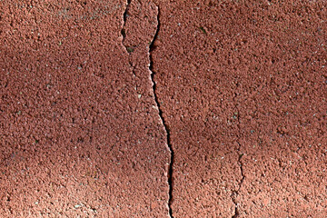 Cracked red cinder brick block wall texture background.