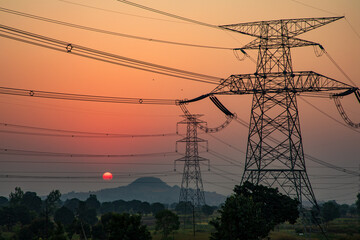 Fototapeta na wymiar high-voltage power lines at sunset, high voltage electric transmission tower
