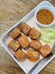 Top view of a plate of Hoi Jo Deep Fried Crab Meat Rolls on a white plate, hanging from crab as the main ingredient.