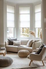 Spacious living room with white roller blinds, bay windows, and a cozy sofa and armchairs.