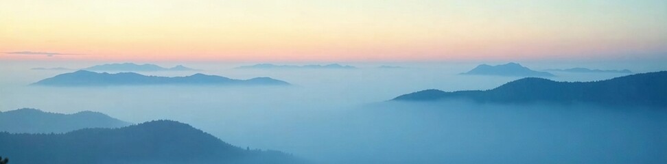 Fototapeta premium Misty morning with layered clouds on blue horizon, misty atmosphere, peaceful morning