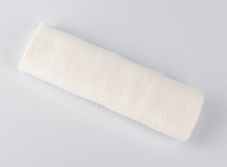 Gauze medical bandage on a white background.