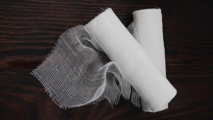 Gauze medical bandage. Two rolls of bandage on a wooden background.