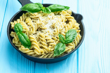 Pasta with basil sauce pesto . Italian food photography . Top view
