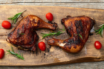 Grilled chicken legs with tomatoes and salad . Top view