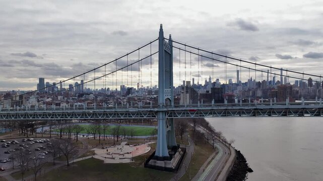 Drone orbiting the RFK Bridge with Manhattan skyline in the background, New York City, USA