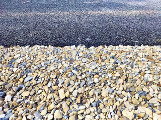 Textured layers of pebbles and stones on a beach during daylight