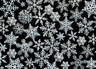 Snowflake designs on a black backdrop, perfect for winter festivities, Christmas, and New Year celebrations. Elegant minimalist wallpaper reflecting seasonal charm and beauty.