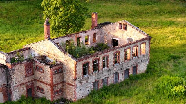 Aerial Rotation Over An Old, Abandoned, Soviet Era Building Still Standing In The Rural Countryside Village Of Ligatne, Latvia. Historic Ruins, Landmarks, And Travel Tours In Gauja National Park.