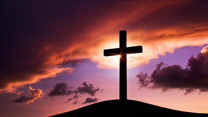 Christian cross standing on hill at sunset with dramatic sky