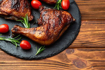 Grilled chicken legs with tomatoes and salad . Top view
