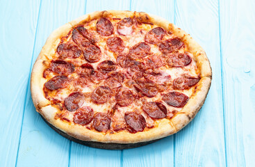 Pizza pepperoni fast food . Top view on rustic background