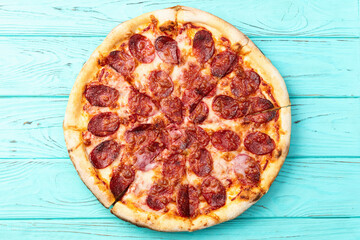 Pizza pepperoni fast food . Top view on rustic background