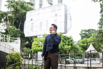 Businessman Calling Using Smartphone While Looking Away