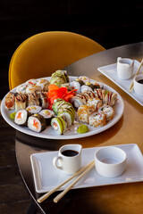 Large Plate Full of Sushi with Chopsticks, Soy Sauce Dishes