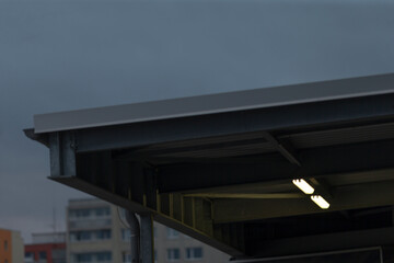The roof of a building stands prominently against a vibrant blue sky in the background, highlighting the architectural beauty of the structure above