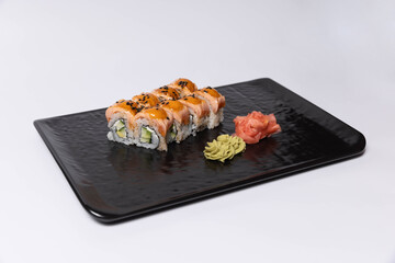 Salmon skin sushi roll served on a black stone, top view