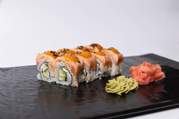 Salmon skin sushi roll served on a black stone, top view