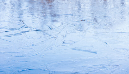 Thin ice covers frozen lake, natural winter background photo