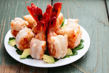 Salad with tiger shrimps , avocado and mango . Top view