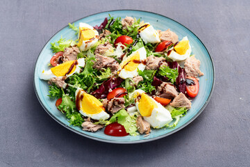 Canned Tuna salad with eggs and tomatoes photography . Top view