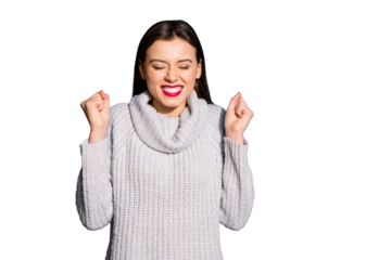Portrait of cheerful girl closing her eyes raising fists wearing grey jumper isolated over blue background