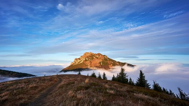 Misty clouds flow like the sea through the Misty Mountains at sunrise
