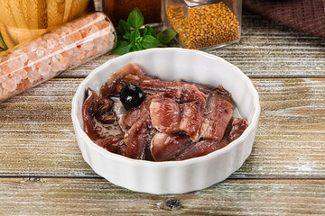 Canned anchovy with oil in the bowl