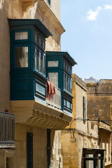 beautiful cityscape view in the small streets of the historic Valetta, Malta. With lots of colorful...