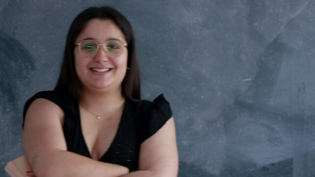 college student with glasses at the blackboard