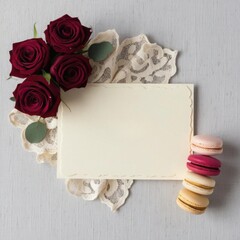 A white card with a red rose and macaron