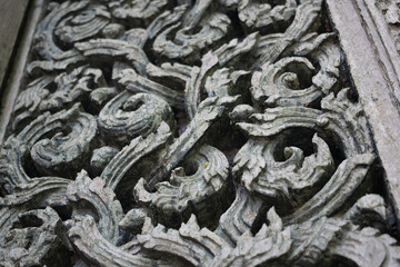 The door of the chapel of Wat Don Sak is made of teak wood, carved with Thai patterns and scrollwork patterns and other Thai architectural pieces, Uttaradit, Thailand