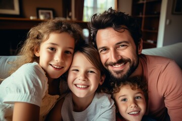 Father and children are cuddling on the couch, enjoying a happy moment together