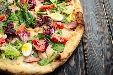Italian pizza caesar with eggs salad chicken tomatoes and mozzarella photography. top view