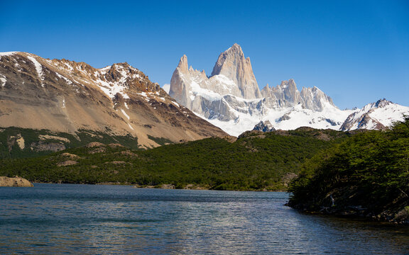 A serene view of Mount Fitz Roy in Patagonia, Argentina, captures the majesty of this iconic peak at sunrise. Ideal for promoting outdoor adventures, nature conservation. glow of the morning sky