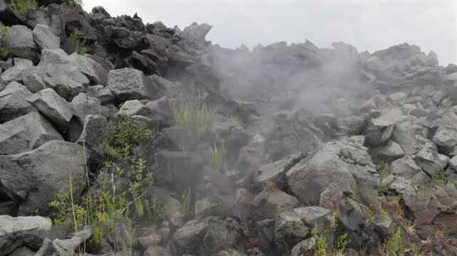 Steam rises from geothermal vent beneath volcanic rocks at Paricutin Volcano, Michoac&aacute;n, Mexico. Boom jib up shot
