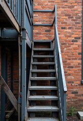 Exterior Metal Staircase Against Brick Wall

