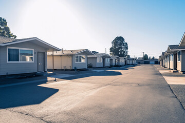 Fototapeta premium Urban affordable housing, compact multi-story building with a modern facade, small balconies, and a paved courtyard