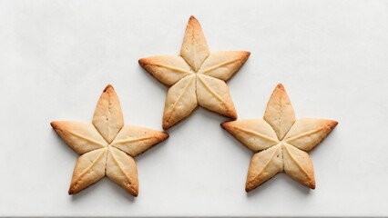 Three star-shaped cookies on white surface
