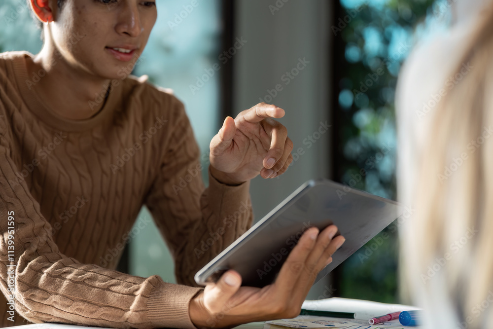 Wall mural modern ux ui designer working on tablet in bright office environment for innovative digital solution