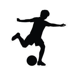 Silhouette of a boy playing soccer