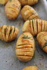 Fresh out of the oven baked and sliced potato with salt and italian herbs for lunch and dinner