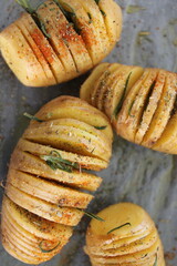 home made oven baked sliced potatoes with salt and fresh rosemary herbs