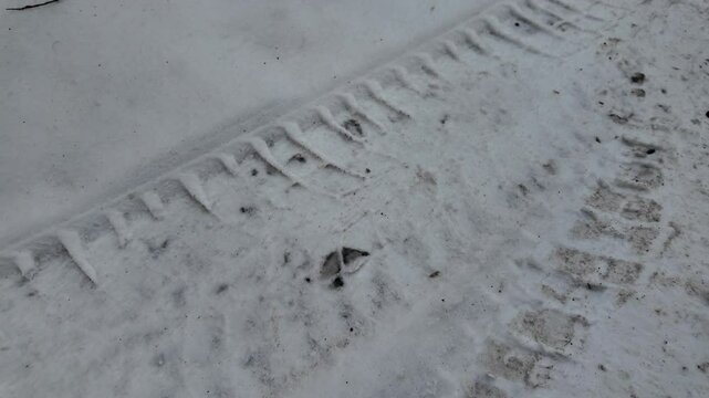 tire tracks on snow. tire tread marks on ground. winter tires. winter tire imprint on sega and ice. slow motion video
