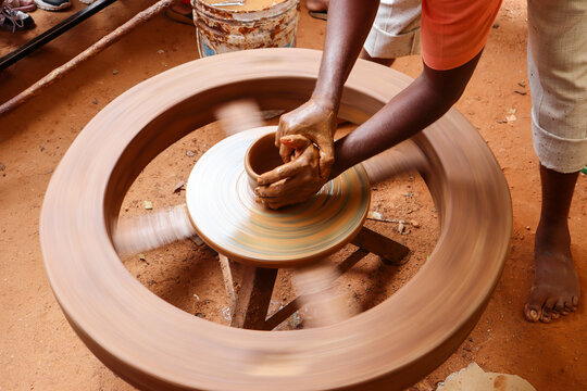 Mysuru, Karnataka, India-December 14 2024; A Potter is using his hands to give a shape to a Pottery object in the traditional method in India.