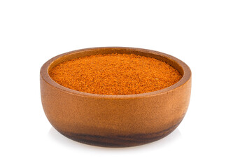 Paprika powder in the wooden bowl isolated on white background.