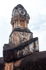 Wat Phra Si Rattana Mahathat Chaliang Khmer Ruin with a walking Buddha in classical Sukhothai style and apsara on front mini-prang