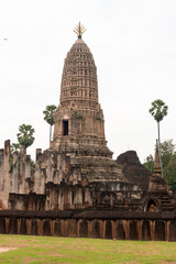 Wat Phra Si Rattana Mahathat Chaliang Khmer Ruin with a walking Buddha in classical Sukhothai style and apsara on front mini-prang