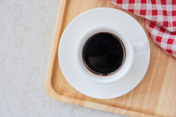 A white  cup of Hot black coffee , top view